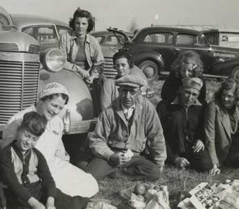 Historical photo of a group of people and car