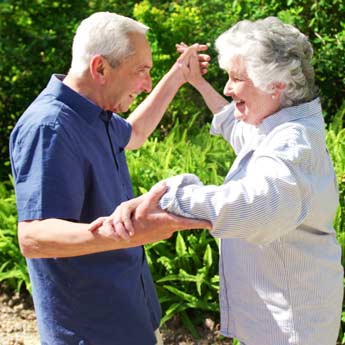 Happy senior couple in garden outside